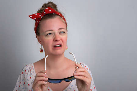 Young caucasian woman girl with red sunglasses sunburn on her face.の写真素材