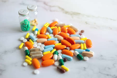Close up of colorful pile of medicine pills on white background. Healthcare, overdose or treatment conceptの写真素材