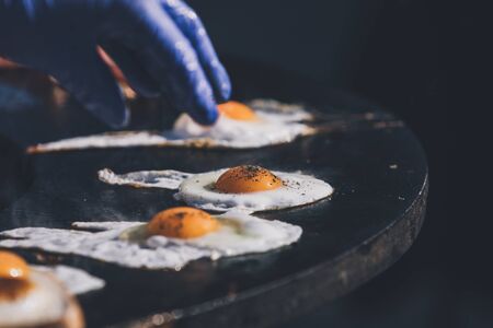 frying egg on open fire panの写真素材