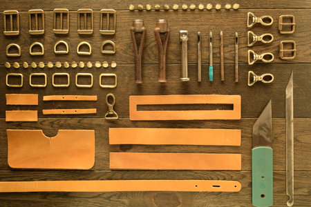 Leather workshop, handbag manufacturing industry, hand craft. Numerous metal elements bag hardware...