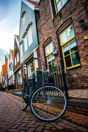Common bicycle on Holland town parked next to houseのeditorial素材