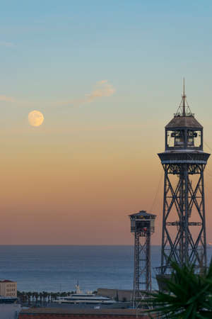 Barcelona sunset bay view with lighthouse and moonの写真素材