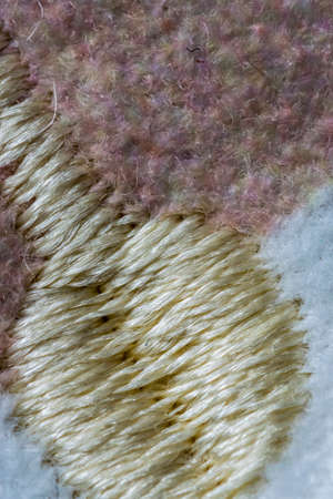 White, brown and yellow stitches wool textile pattern macro, clothingの写真素材