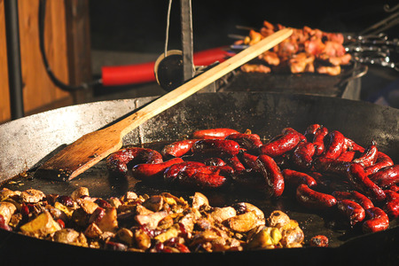 Street food at the fair, Wok, frying sausages, yummyの写真素材