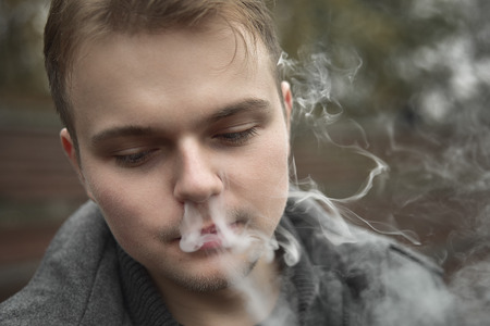 Smoking guy in the Park, portraitの写真素材
