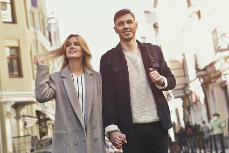 Young couple walk at the street on sunny dayの写真素材