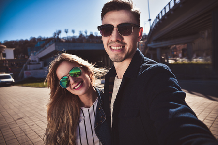 Pretty tourists make funny photos for travel blog in Europe.の写真素材