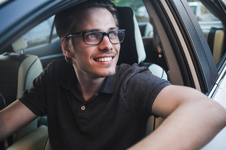 Enjoy the drive. Image of young handsome guy sitting in car.の写真素材