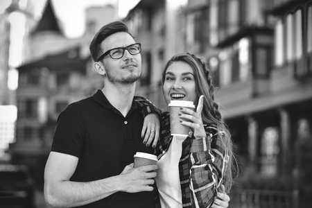 Portrait of happy couple walk on the street with coffee.の写真素材
