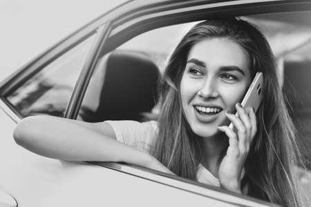 Portrait of a handsome girl driving her carの写真素材