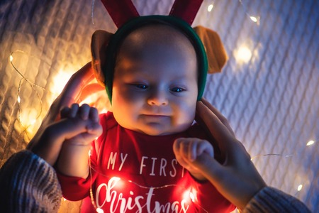 Baby girl wearing Santa's crawling with very determined facial expression. First Christmas.の写真素材