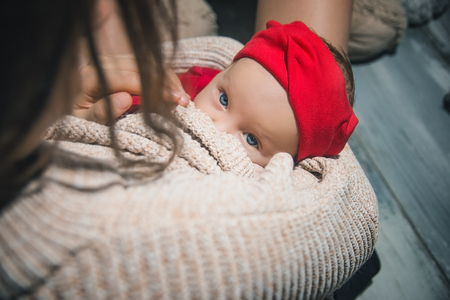 Soft photo of young mother feeding baby at home.の写真素材