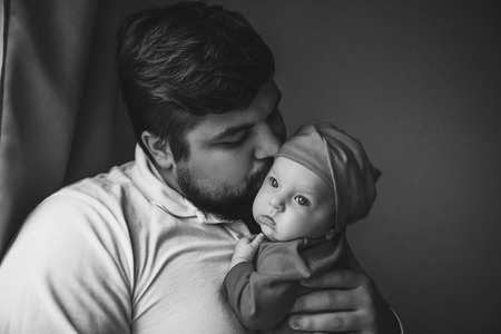 Father and newborn lying on the bed.の写真素材