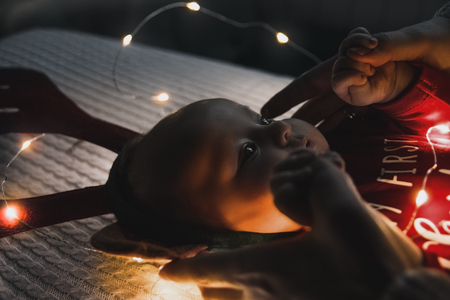 Baby girl wearing Santa's crawling with very determined facial expression.の写真素材