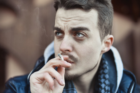 Man smoking cigarette Close up of an smoking cigaretteの写真素材