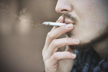 Man smoking cigarette Close up of an smoking cigaretteの写真素材
