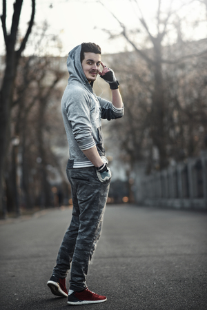 Sporty young man working out at early morning with background sunriseの写真素材