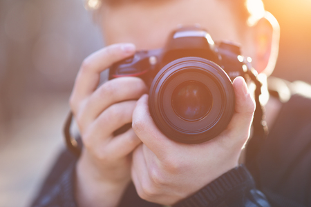 Man with photo camera Fashion Travel Lifestyle outdoor while standingの写真素材
