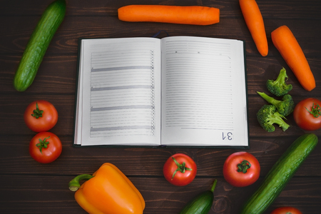 Diet mode, image of vegetables and a diet menu plan on a notepadの写真素材