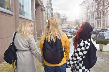 Three girls walking in the school yard view from back friendship conceptの写真素材
