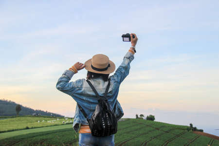 a celebration of a female photographer at the top of Indonesia's hill. cheerful expression of adventurers in casual clothesの写真素材