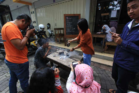 the photographers are taking pictures of the drink and food menu on the cafe page. behind the scenes activities with a food photographer. pasuruan, Indonesia. January 2020のeditorial素材