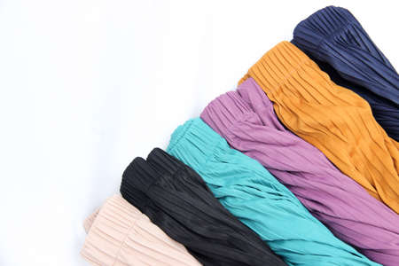 colorful fabric roll with isolated white background. women's skirts with various colorsの写真素材