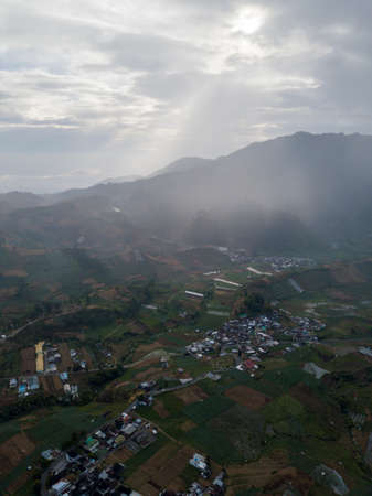 Aerial view of a village in the Dieng Plateau, Indonesia. morning view of the countryside among the mountainsの写真素材