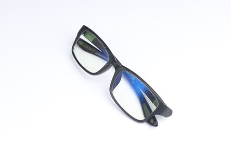 clear glasses with black frame on isolated white background. fashion and eye health products. sport glasses with a rubber base materialの写真素材