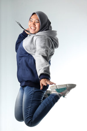 portrait of an Asian woman wearing casual clothes. hooded woman wearing gray jacket isolated on...