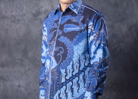 portrait of a man wearing a government service batik. clothes with blue batik motifs. government shirts for formal eventsの写真素材