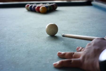close up of the pool player's hand preparing to start the game. The first move of playing billiards...