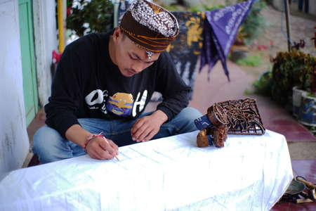 Pasuruan, Indonesia. June 2021. close up of a man making batik typical of the Bromo Tengger tribe. young artists who preserve ethnicity and culture in Indonesiaのeditorial素材