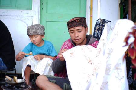 Pasuruan, Indonesia. June 2021. Batik artisans and stamped batik are making batik typical of the Tengger Bomo tribe. teach the next generation to preserve Indonesian ethnicity and cultureのeditorial素材