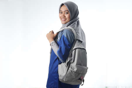 portrait of an Asian woman wearing work or school clothes. hooded women carry a casual backpack. learning or working photo concepts with happy expressionsの写真素材