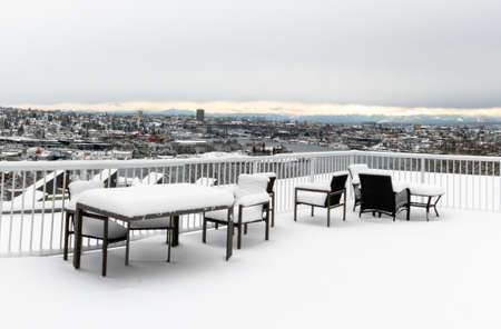 Seattle, Washington - 2019-02-09 - Outdoor dining set at rooftop covered with snow after the snowpocalypse of 2019 in Seattleの写真素材