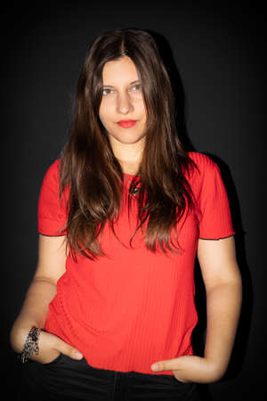 Portrait of woman with black background, green eyes and long hair