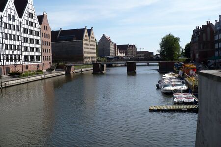 bridge on the canal in the port of Gdansk in Poland between tenements blue water sunny dayの写真素材