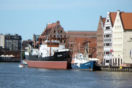 boats ships on the canal in the port of Gdansk in Poland blue water two shipsの写真素材