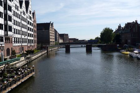 bridge on the canal in the port of Gdansk in Poland between tenements blue water sunny dayの写真素材