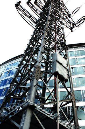 high voltage pole in the city next to the office building dangerの写真素材