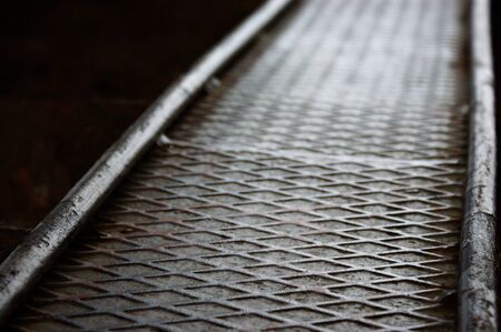 old rusty metal aluminum steel ramp for bicycle footbridge bronze reflection is reflectedの写真素材