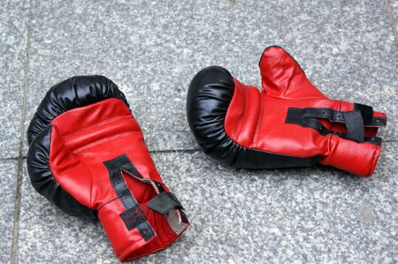 red boxing gloves lying on the streetの写真素材