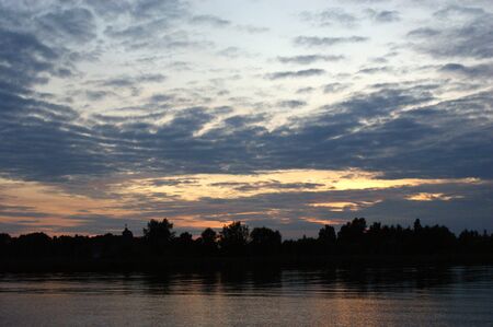 Niegocin lake Mazury Poland sunset on the lake with orange sky cloudy clouds red and purple sunの写真素材