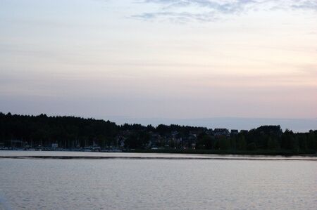 forest on the lake on the lake far away on the horizon green treesの写真素材