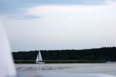 sailboat boat floats on the lake and blue sky sailの写真素材