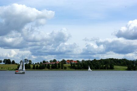 sailboat boat floats on the lake and blue sky sailの写真素材