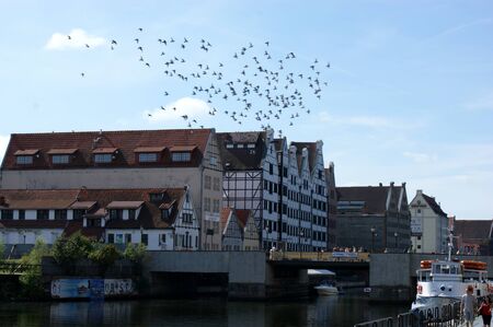 bridge on the canal in the port of Gdansk in Poland between tenements blue water sunny day