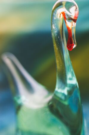 glass figurine made of glass in the shape of a flowing swan transparent figureの写真素材