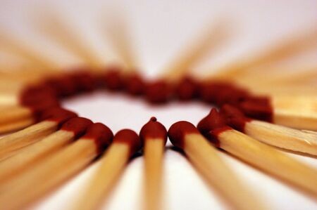 matches arranged into the shape of a red burgundy heart love closeupの写真素材